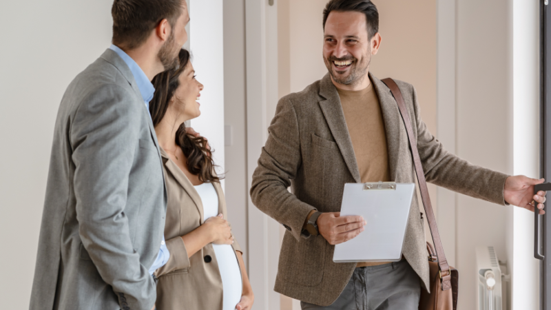 A realtor showing a couple around a home