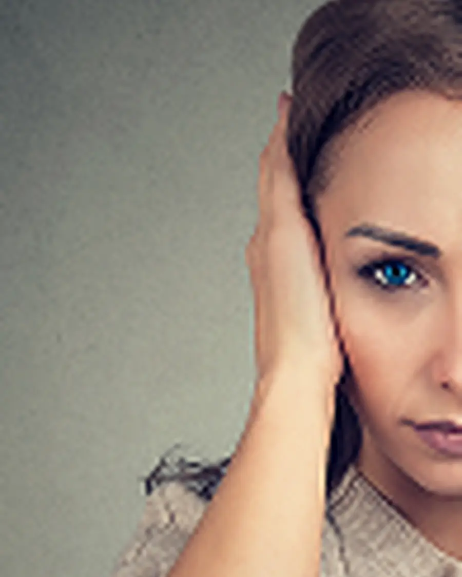 woman covering ear